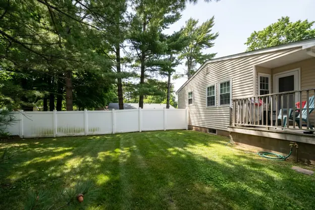White vinyl fence around a Central Jersey split-level home