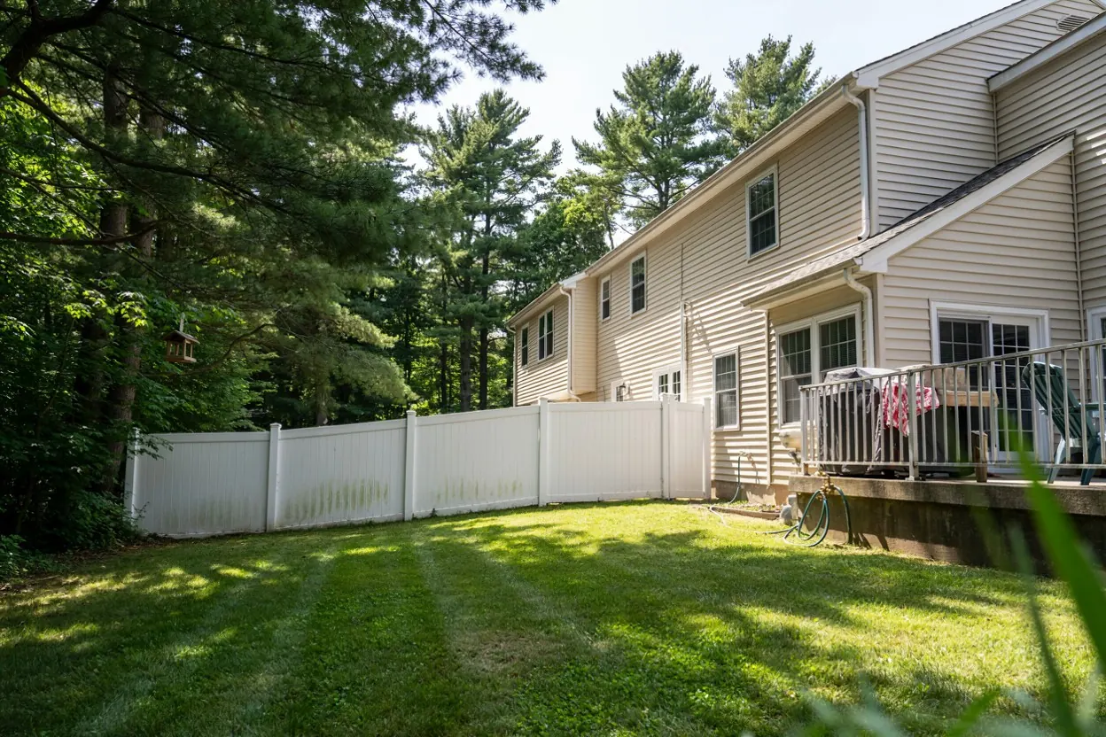 White vinyl fence around a Central Jersey split-level home