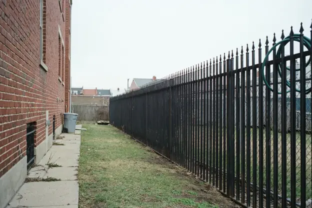 Ornamental iron fence behind a North Jersey row house