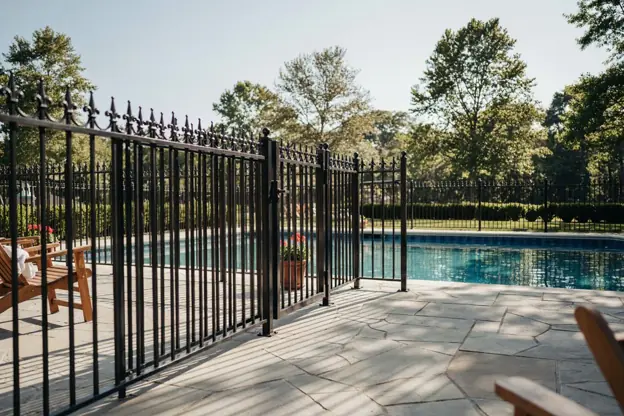 Black aluminum ornamental fence around a New Jersey backyard pool